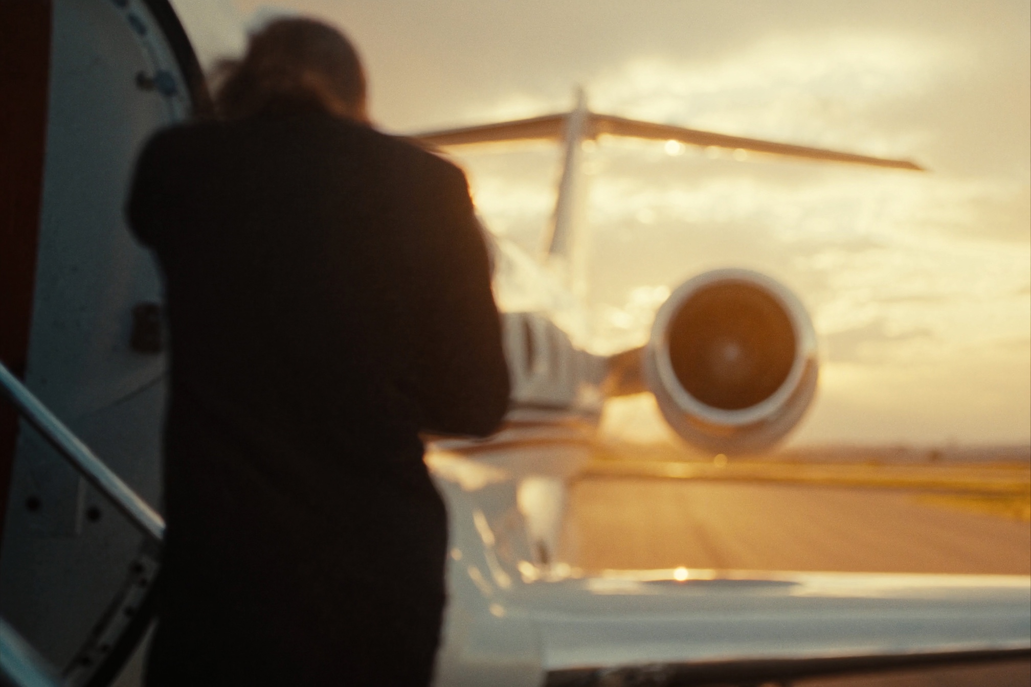 Private jet boarding stair on the tarmac at dusk